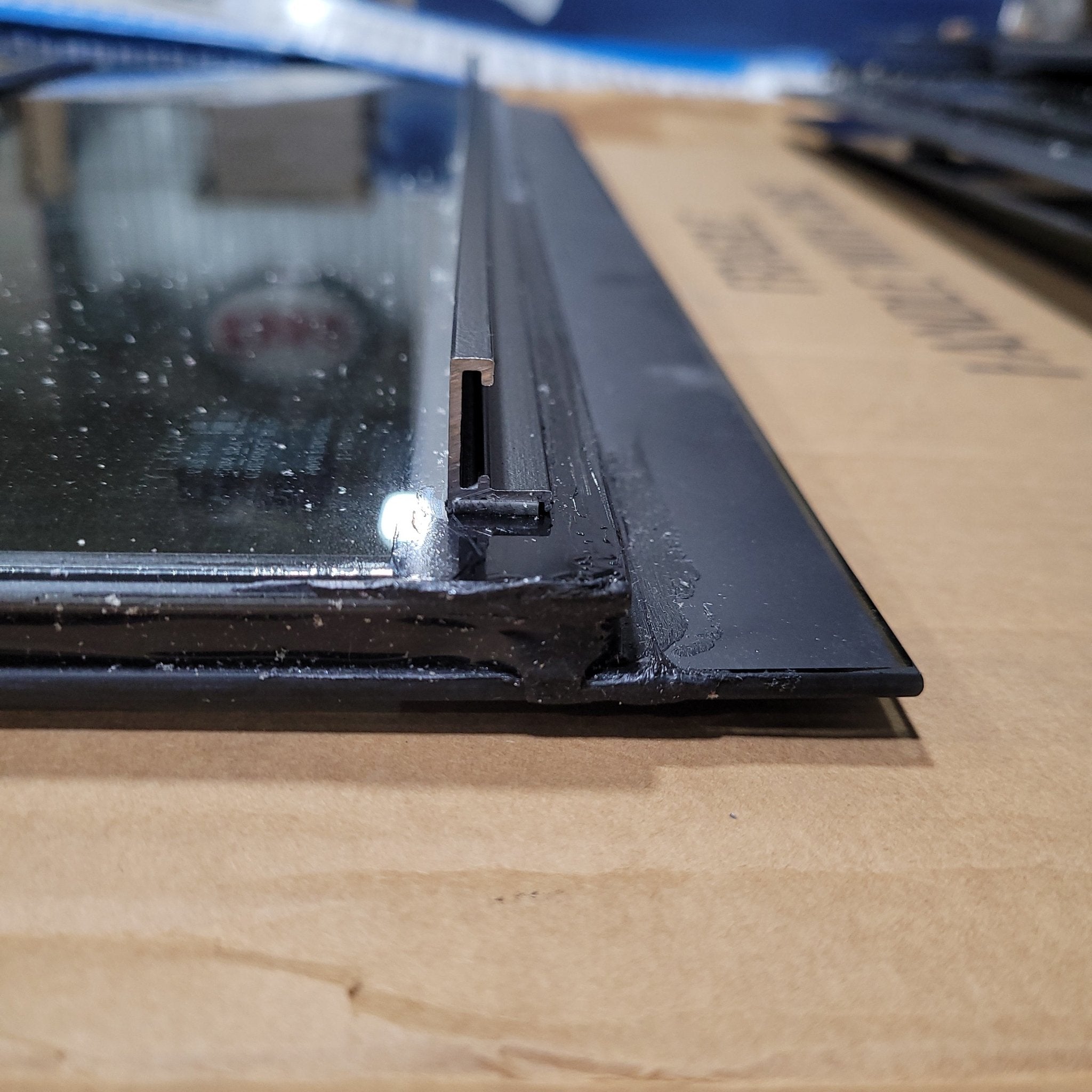 Used Black Radius Frameless Opening Window : 24 1/2" X 10 1/2" X 1/2" D - Young Farts RV Parts