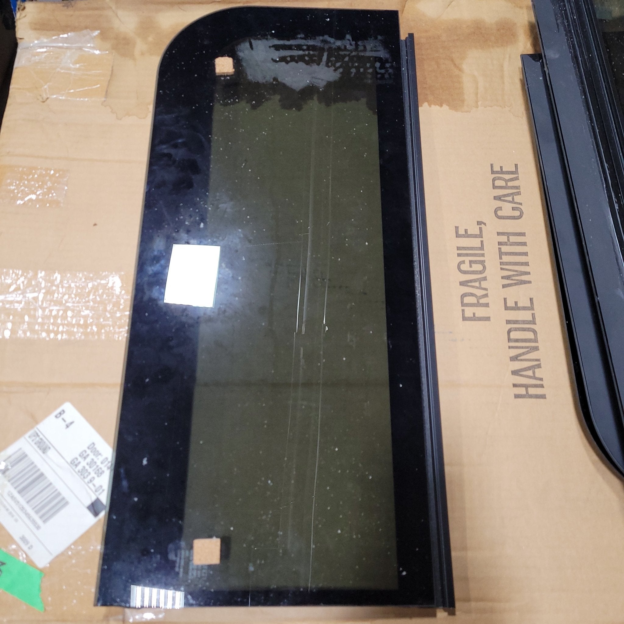 Used Black Radius Frameless Opening Window : 24 1/2" X 10 1/2" X 1/2" D - Young Farts RV Parts