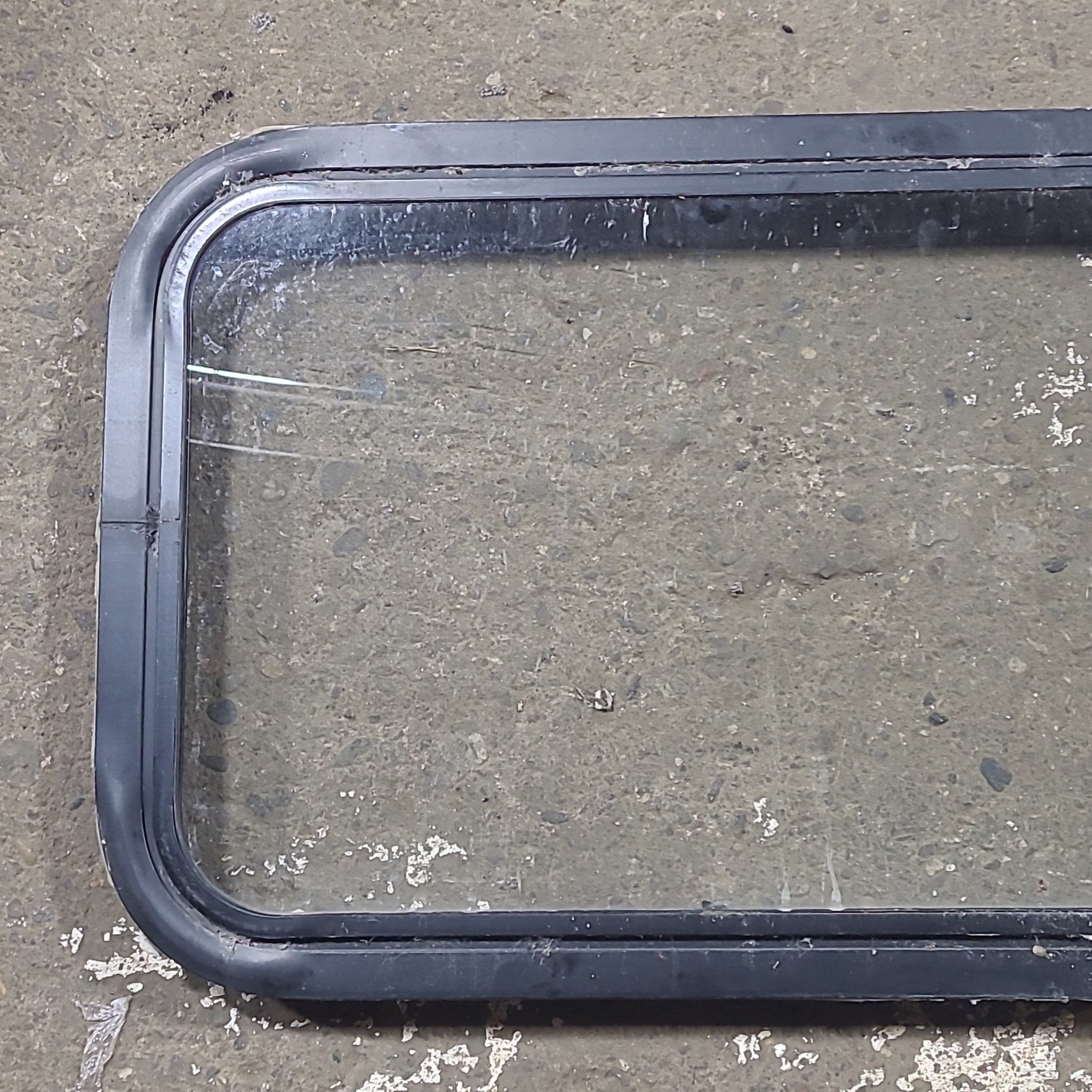 Used Black Radius Non Opening Window : 24 1/4" W x 16 3/4" H x 1 7/8" D - Young Farts RV Parts