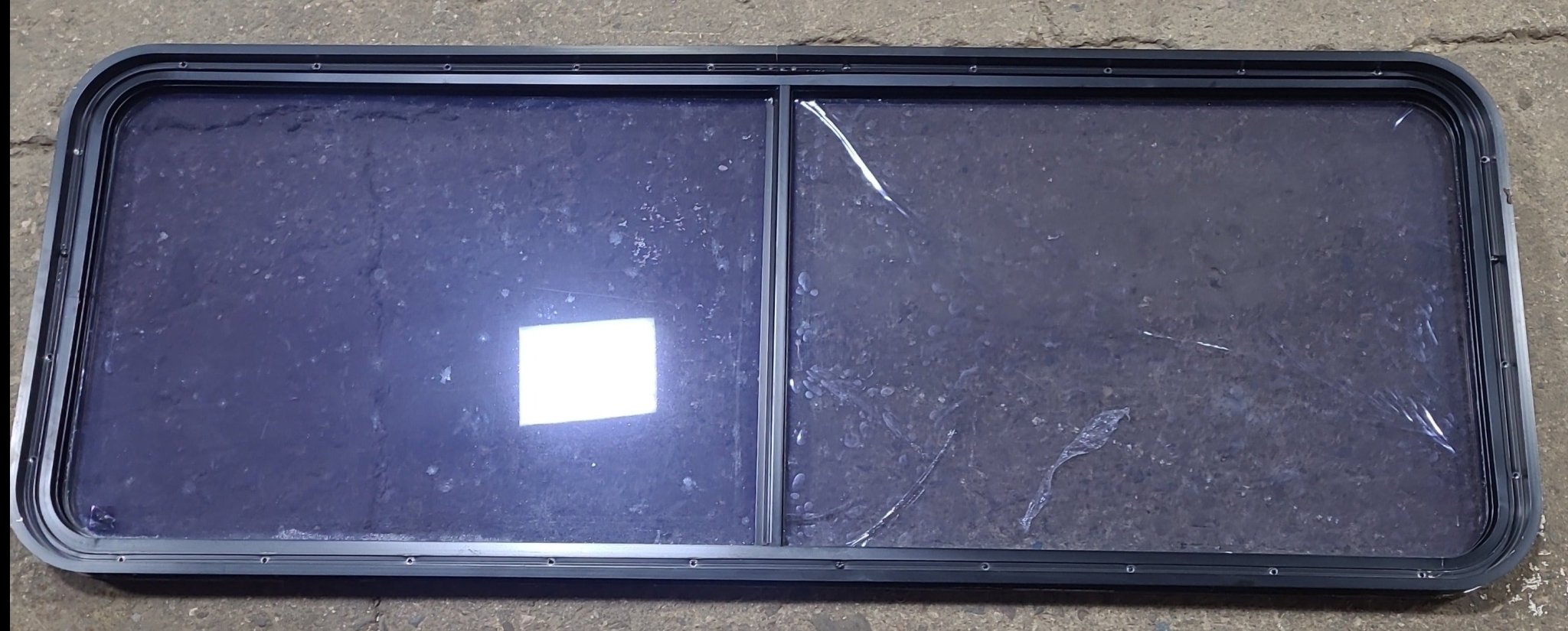 Used Black Radius Non Opening Window : 60 1/2" W x 21 3/4" H x 1 3/4" D - Young Farts RV Parts