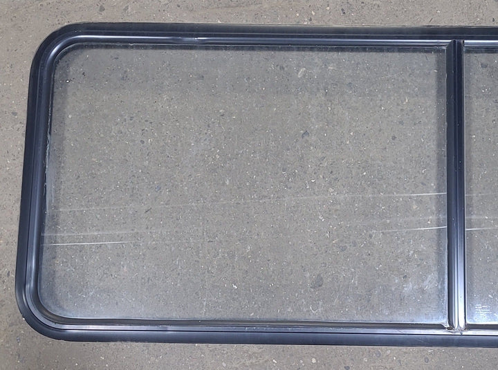 Used Black Radius Non-Opening Window : 60 1/4" W X 21 3/8" H X 1 7/8" D - Young Farts RV Parts