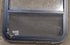 Used Black Radius Opening Window : 24 1/4" W x 35 1/4" H x 1 1/4" D - Young Farts RV Parts