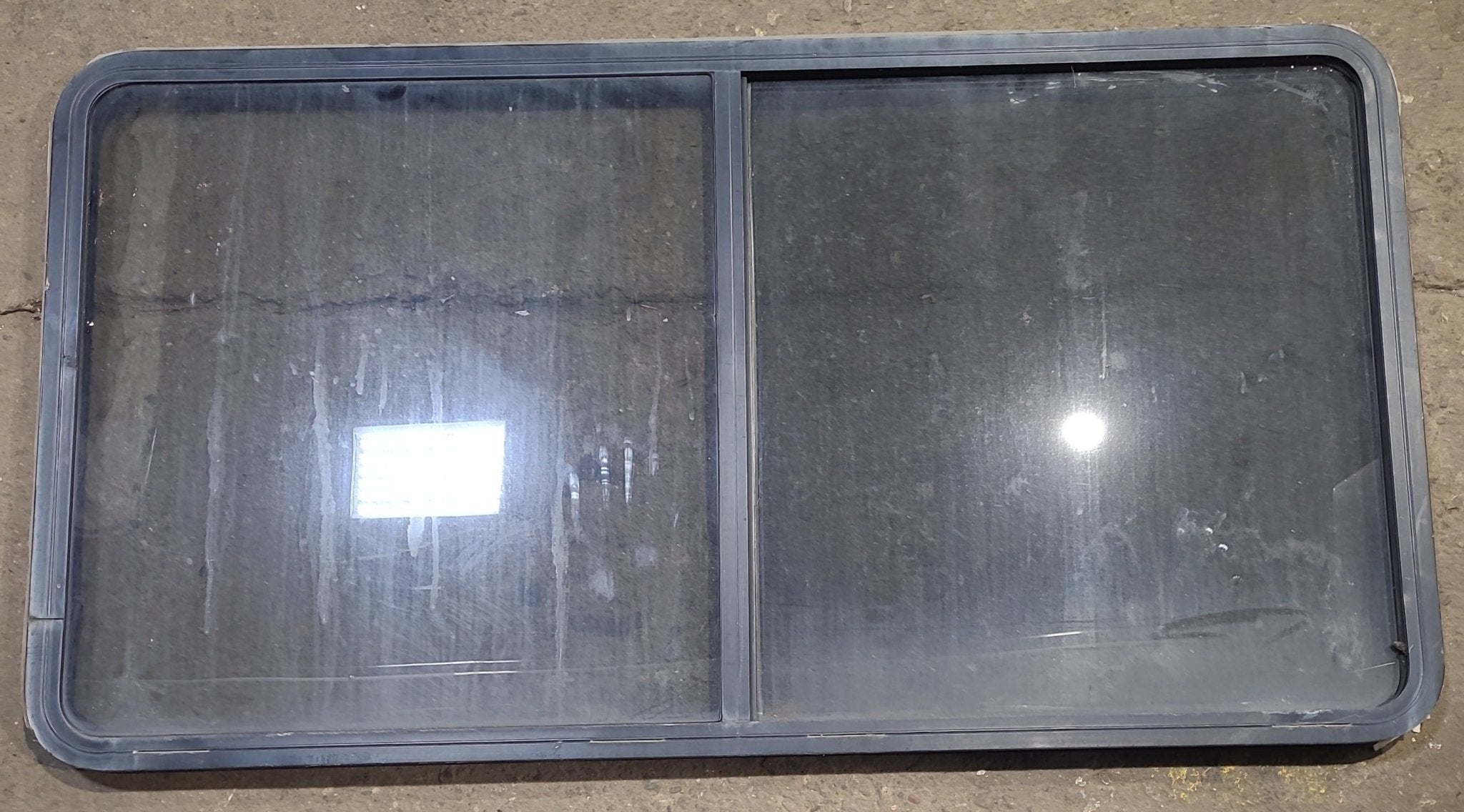 Used Black Radius Opening Window : 57" W x 27 3/4" H x 1 7/8" D - Young Farts RV Parts