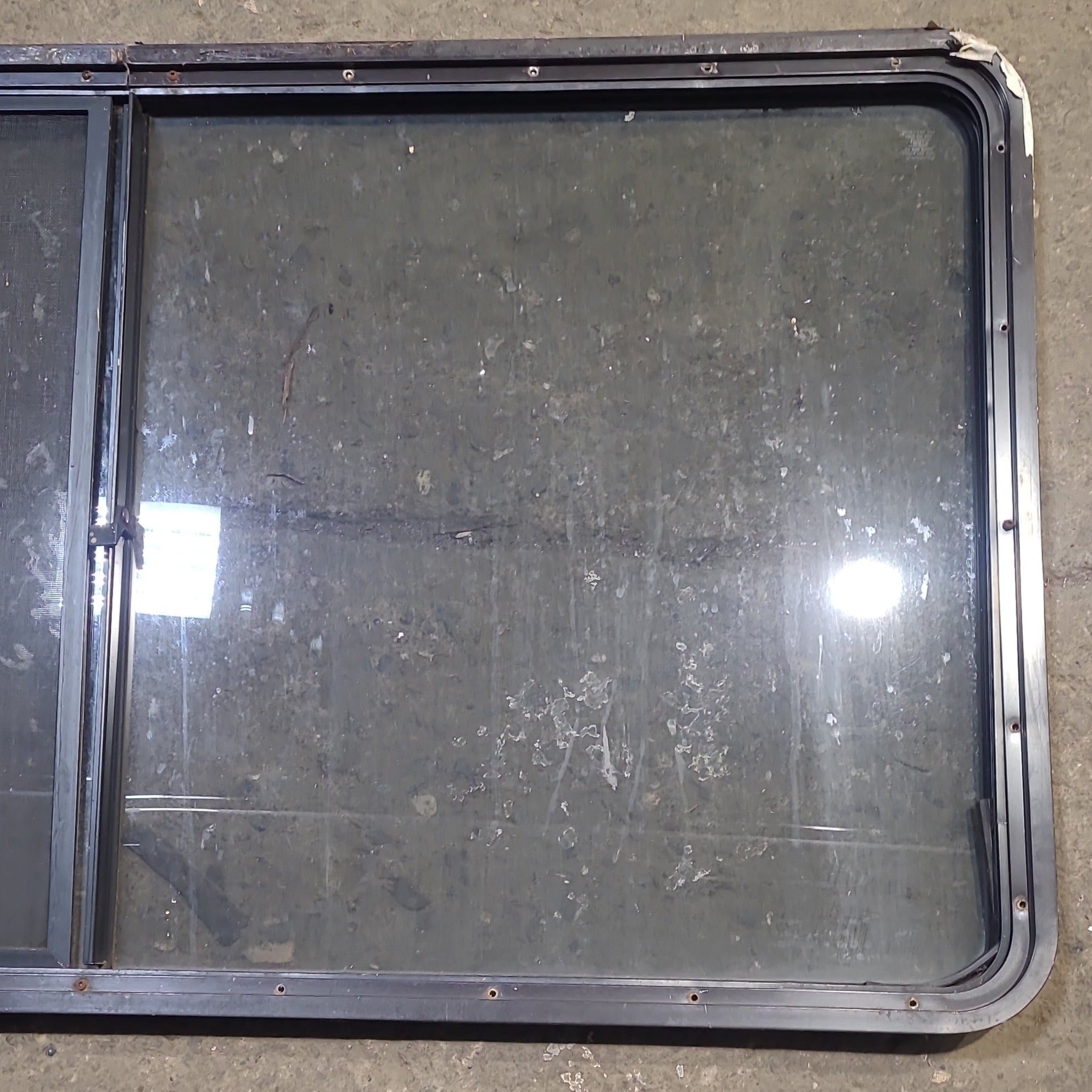 Used Black Radius Opening Window : 57" W x 27 3/4" H x 1 7/8" D - Young Farts RV Parts